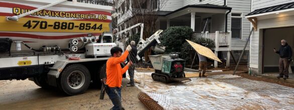 Contractor preparing driveway rebar layout for concrete pour with Quick Mix Concrete mobile mixing truck on site