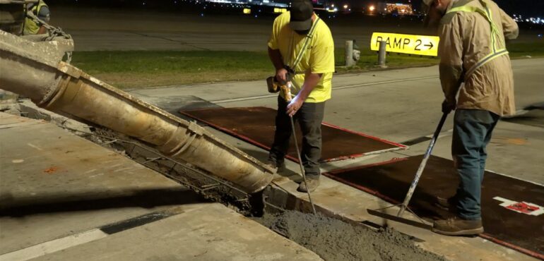 Quick Mix Concrete crew pouring a nighttime concrete repair at Hartsfield-Jackson Atlanta International Airport from the mobile mixer chute