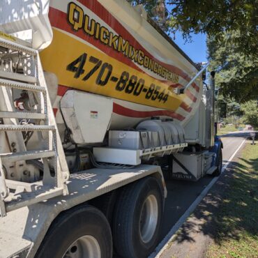 Quick Mix Concrete volumetric mixer truck parked on a residential street in Austell, Georgia for a short load concrete delivery