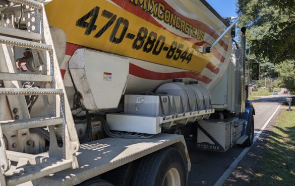 Quick Mix Concrete volumetric mixer truck parked on a residential street in Austell, Georgia for a short load concrete delivery
