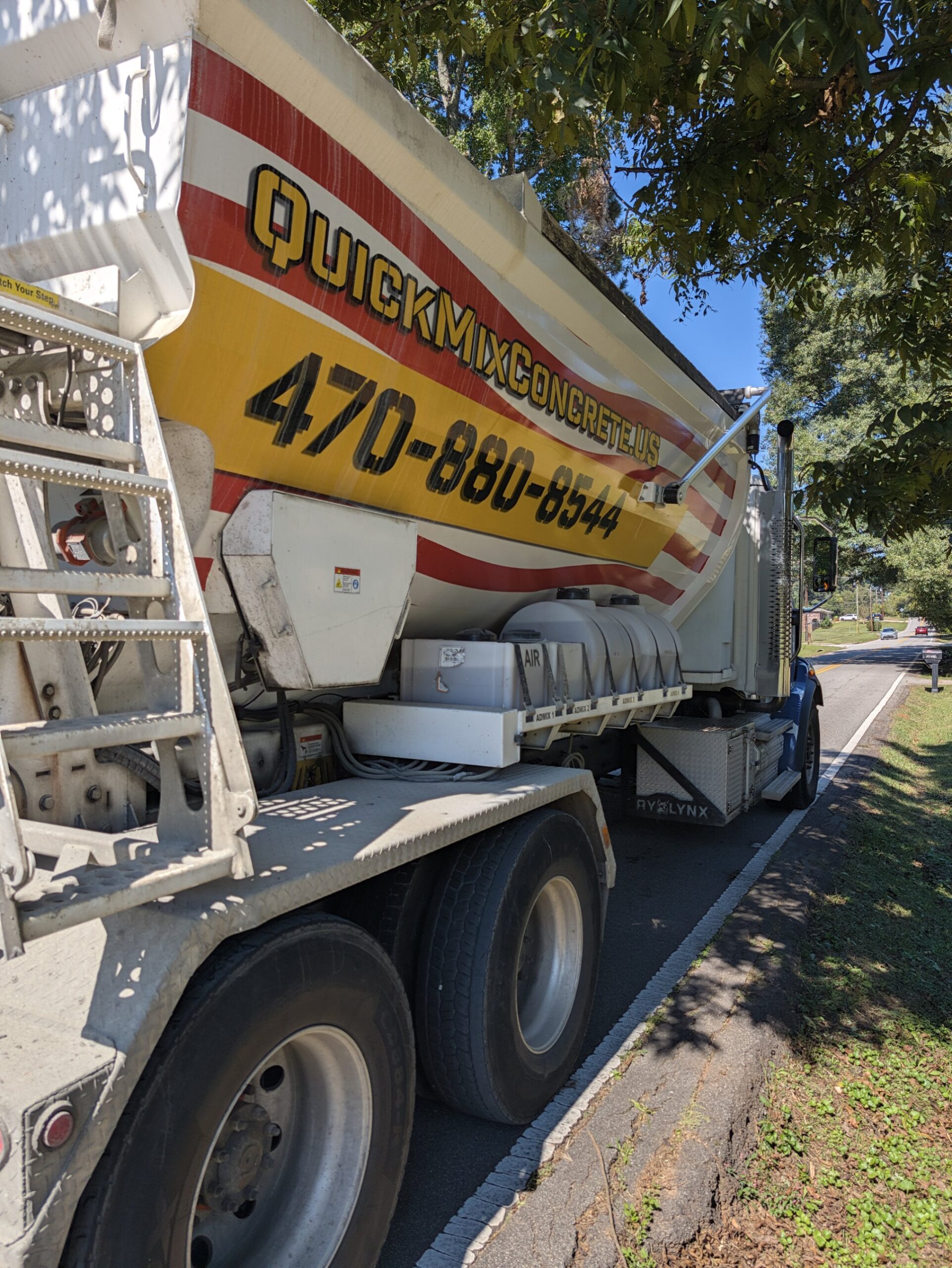Quick Mix Concrete volumetric mixer truck parked on a residential street in Austell, Georgia for a short load concrete delivery