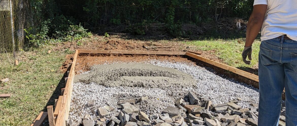 Fresh 3,000 PSI concrete placed on a gravel base inside wood forms for a backyard pad in Austell, Georgia