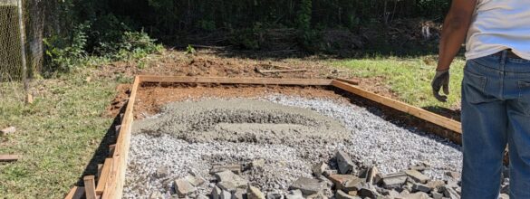 Fresh 3,000 PSI concrete placed on a gravel base inside wood forms for a backyard pad in Austell, Georgia
