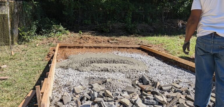 4.5 yard short load concrete pad pour in Austell, GA Fresh 3,000 PSI concrete placed on a gravel base inside wood forms for a backyard pad in Austell, Georgia