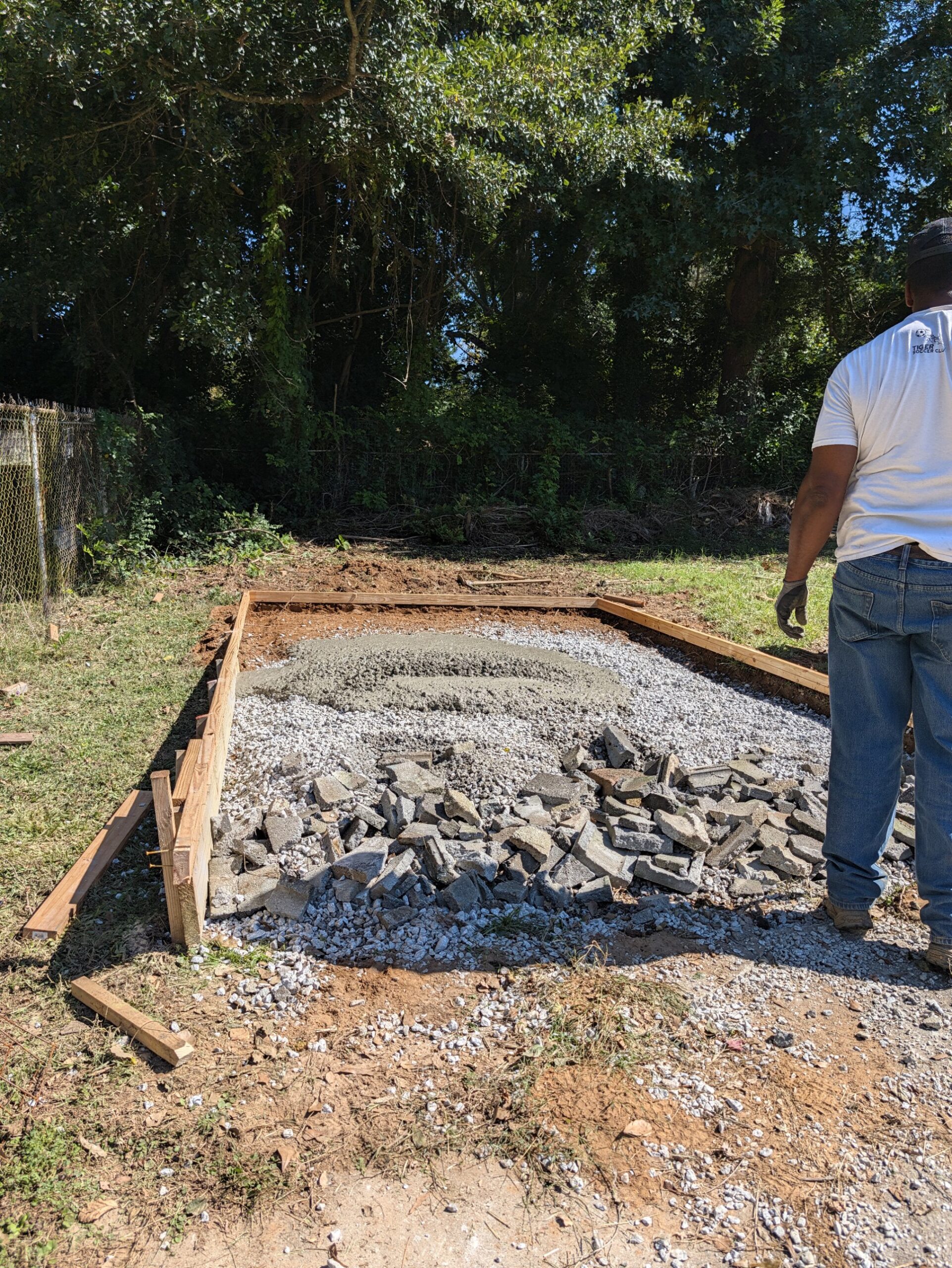 Fresh 3,000 PSI concrete placed on a gravel base inside wood forms for a backyard pad in Austell, Georgia